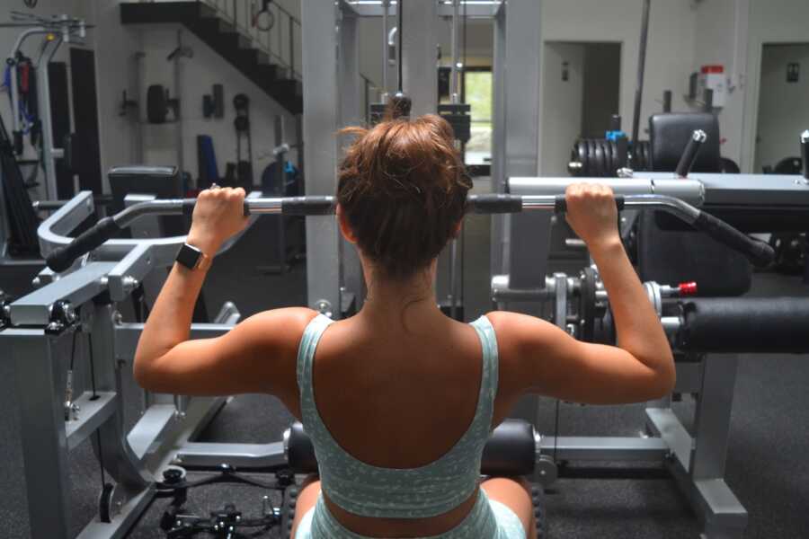 back shot of woman's upper body while working out