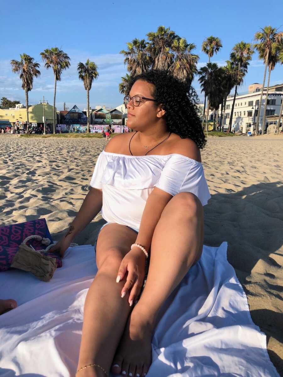 body positivity activist in a white swimsuit at the beach