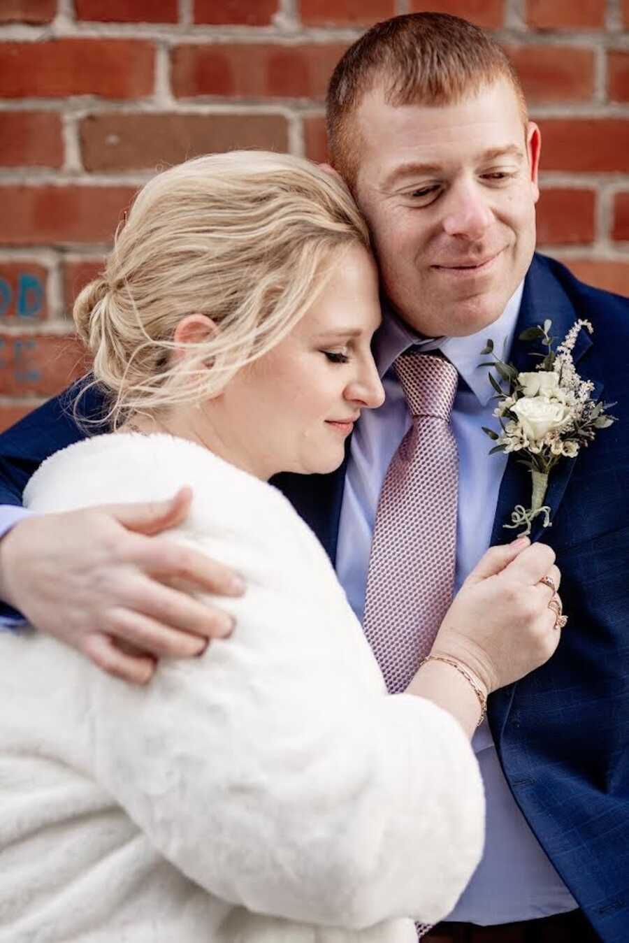 breast cancer patient being held by her husband