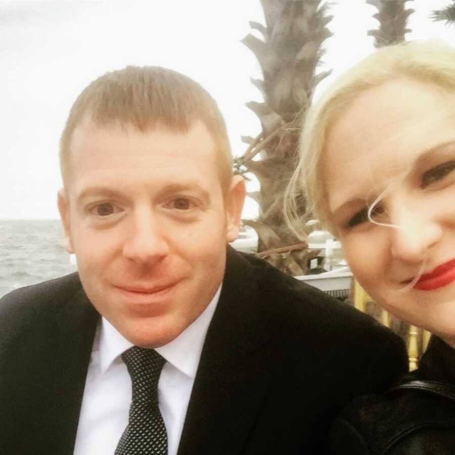 breast cancer patient sitting with her husband at a pier