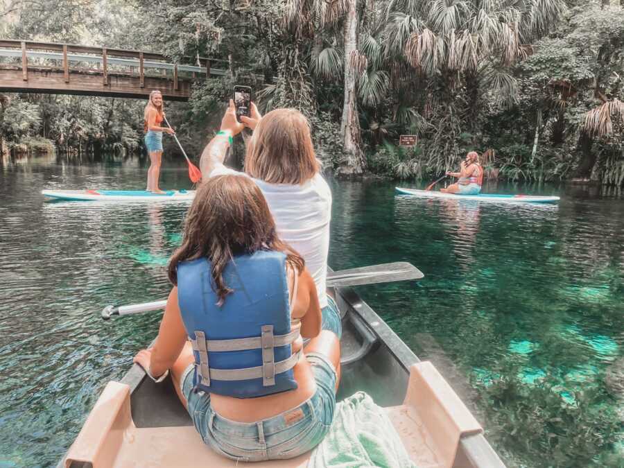 Family canoes and paddleboards on vacation in Florida.