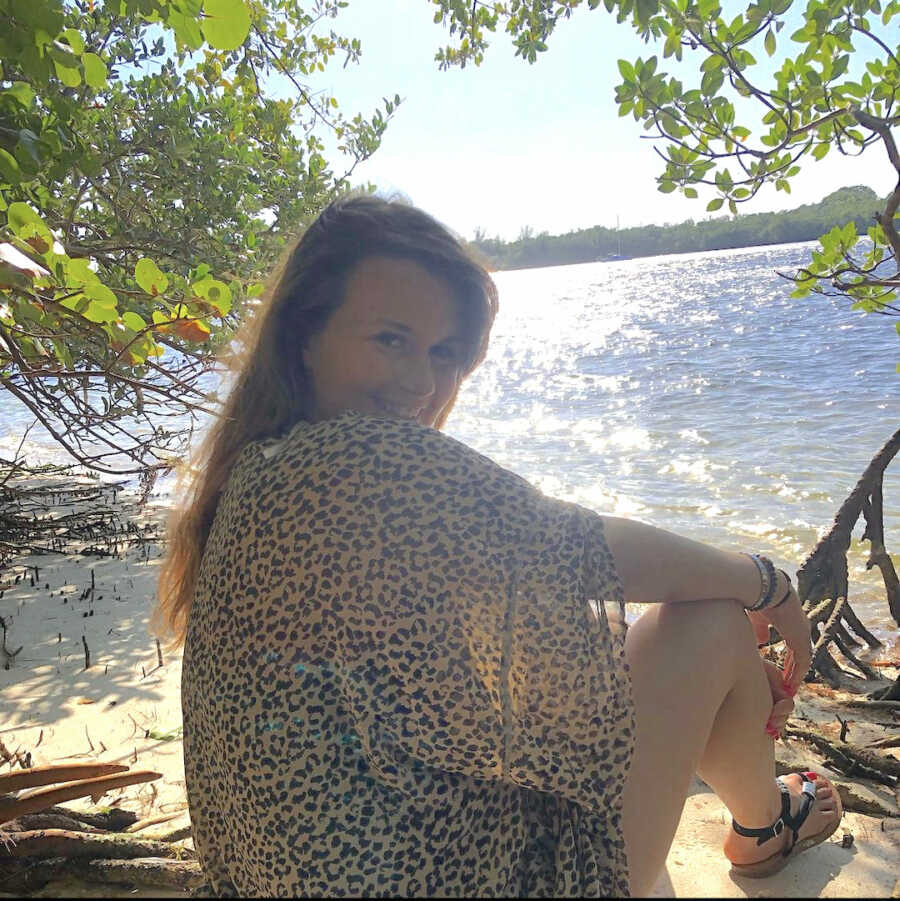 chronically ill woman sits on beach