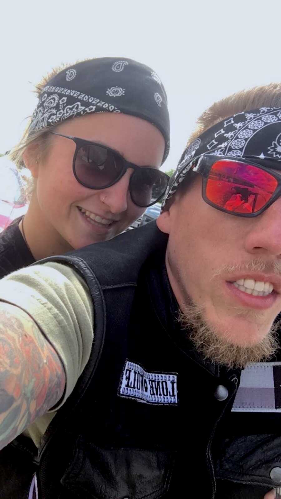 couple wears matching bandanas and sunglasses