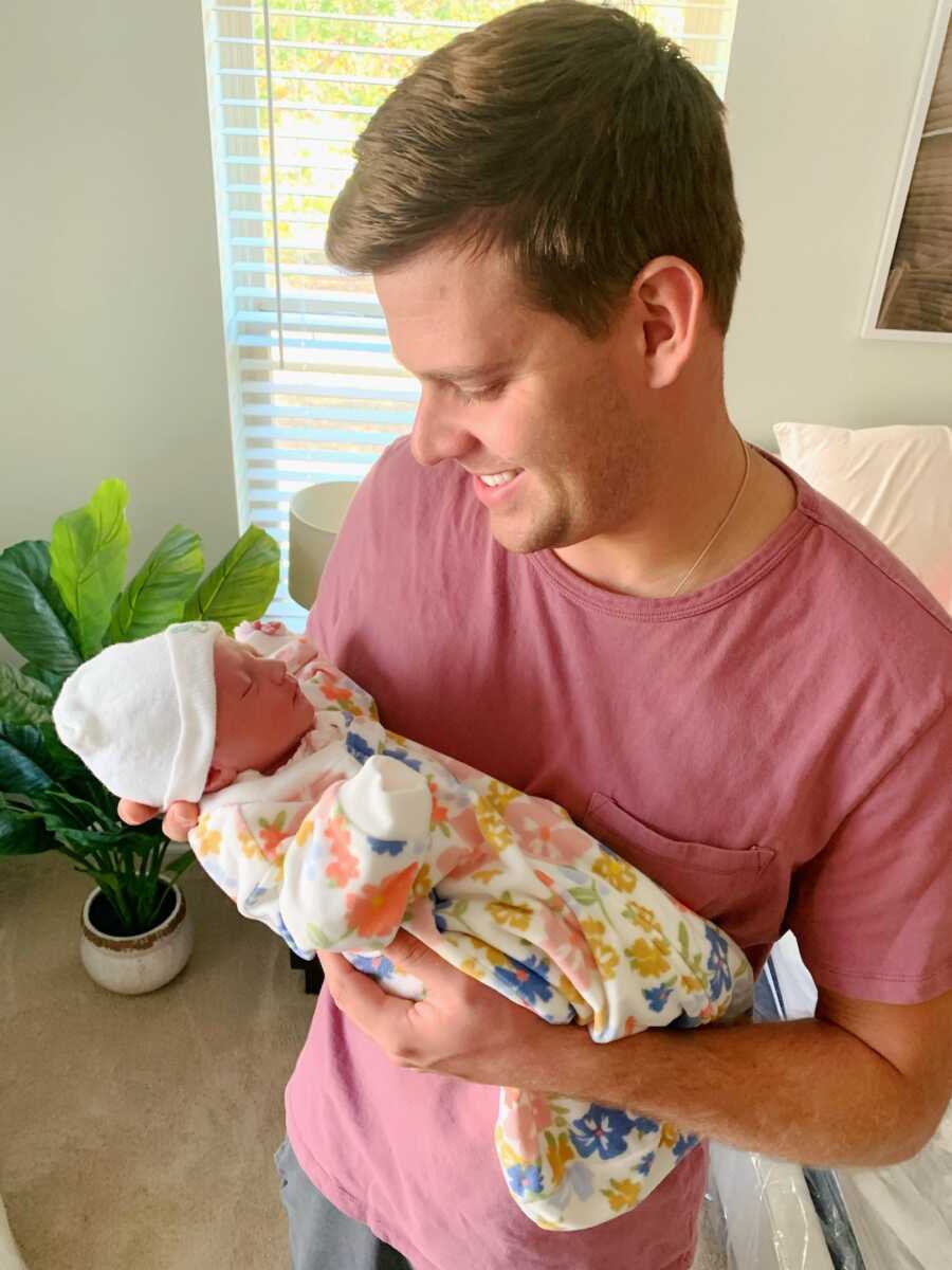 dad holding daughter looking at her