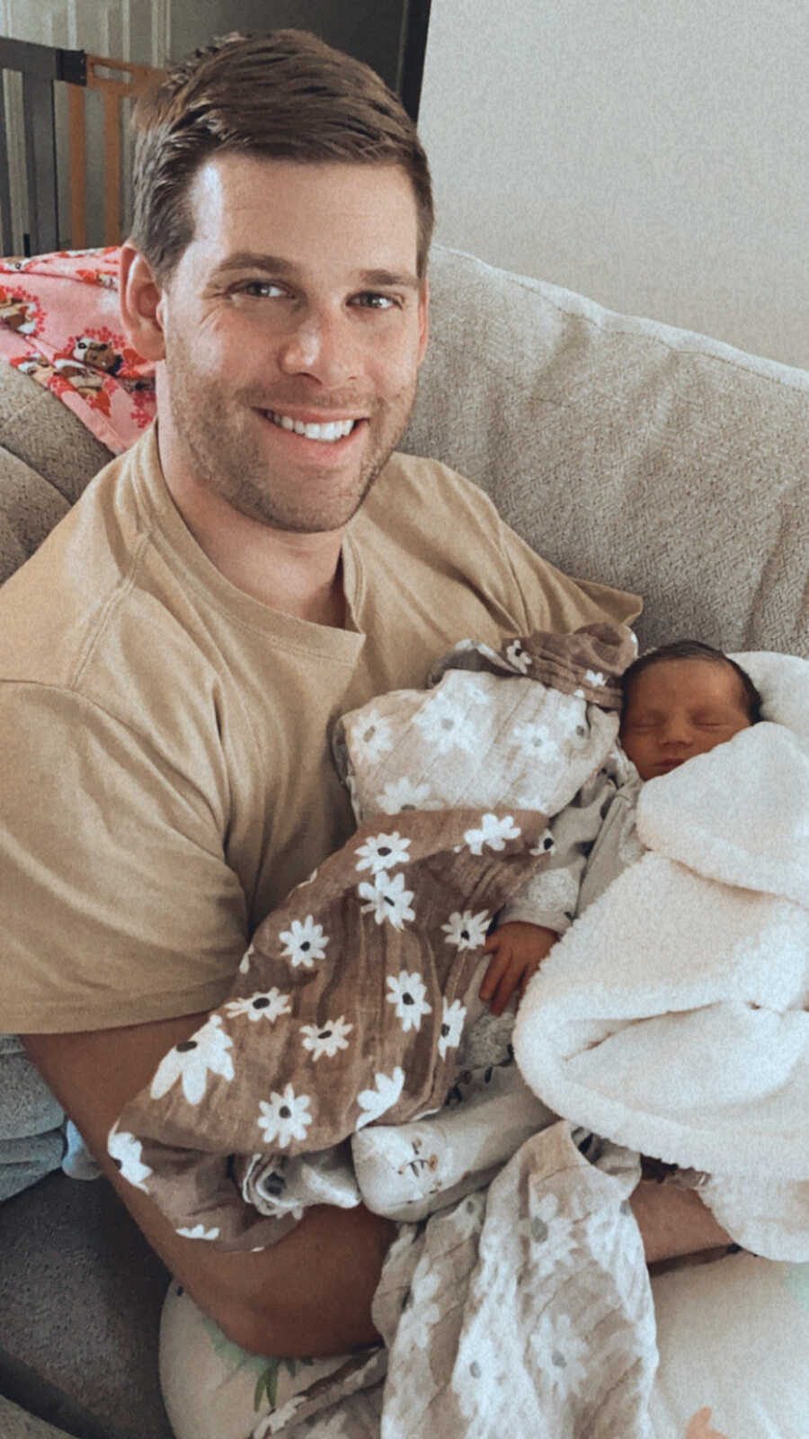 dad sitting holding his baby daughter