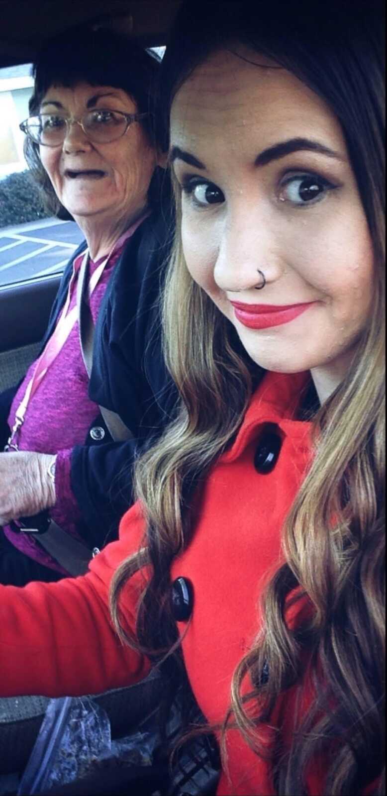 Caretaker daughter and her mom smile in the car