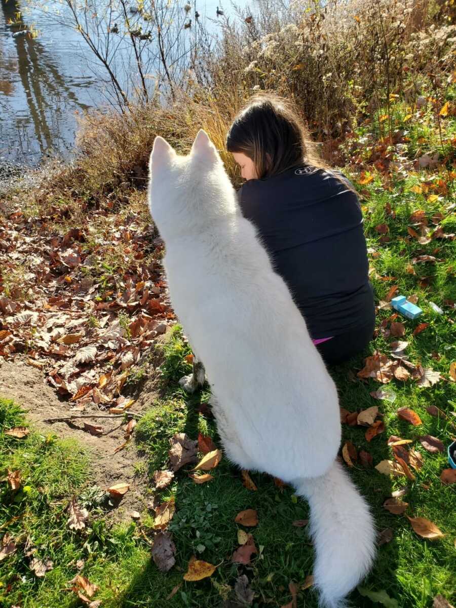 chronically ill woman sitting next to her dog