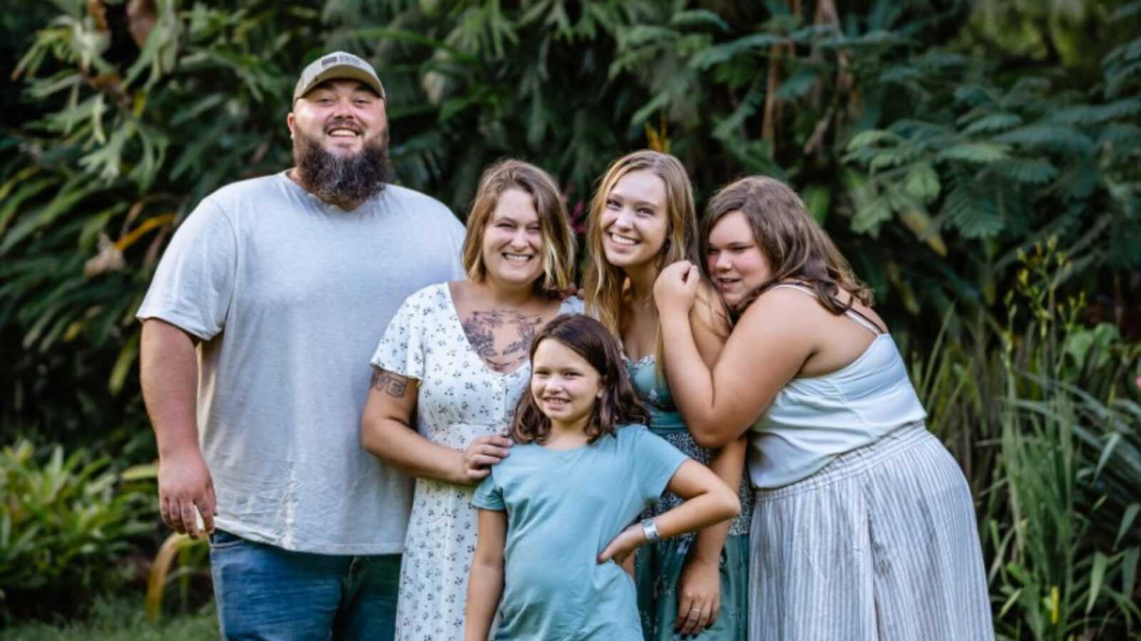 Bio mom and adoptive parents take picture with their entire family while on vacation in Florida.
