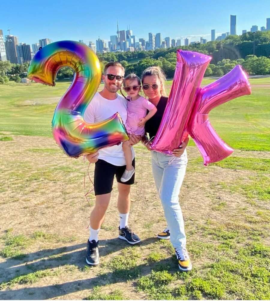 former alcoholic with family celebrating 2k marathon run with balloons