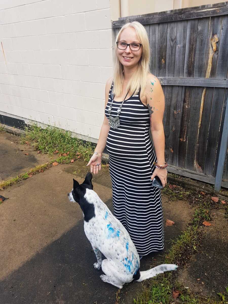 formerly abused pregnant woman with a dog