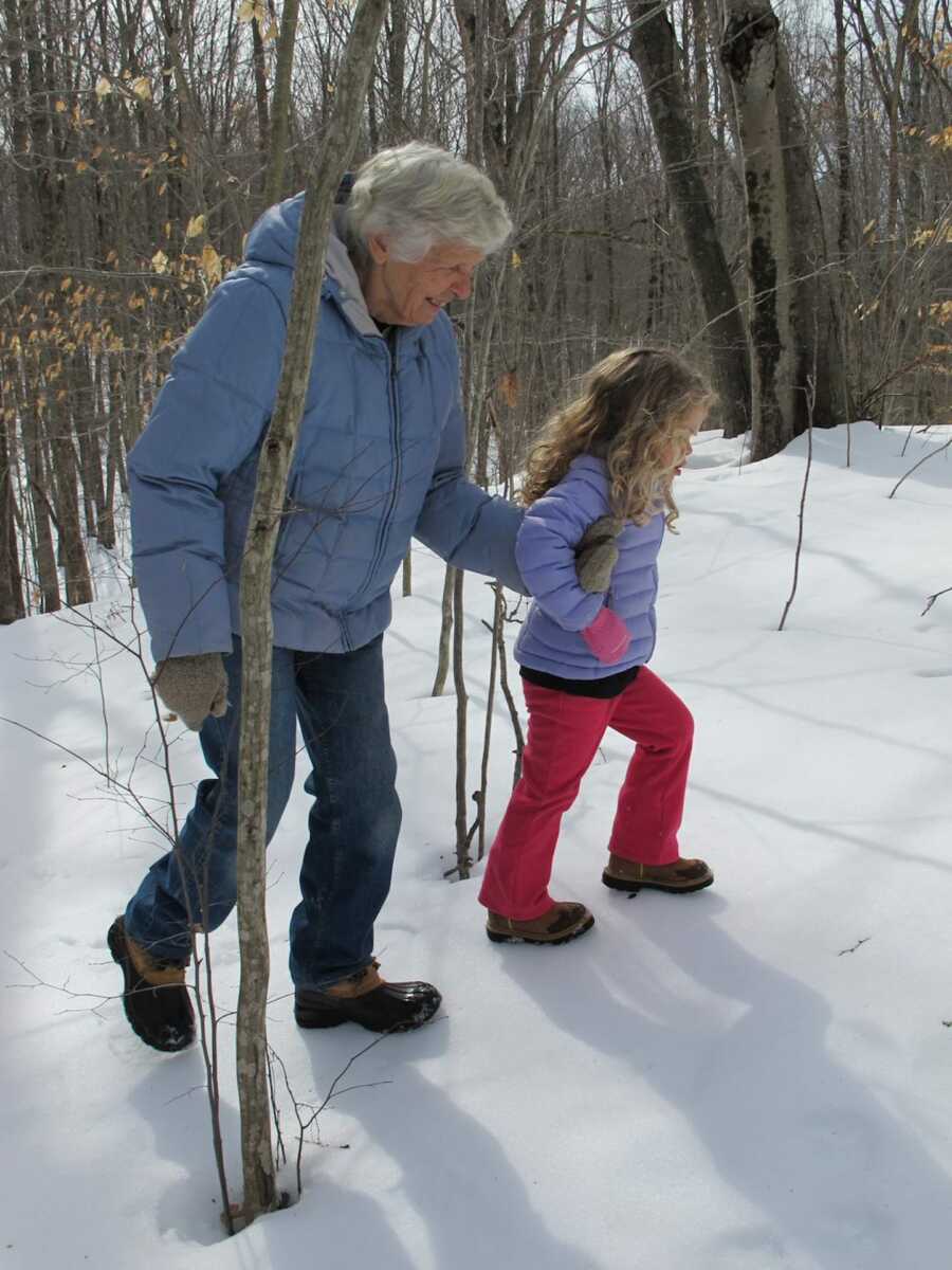 grandma walks with young girl in snow