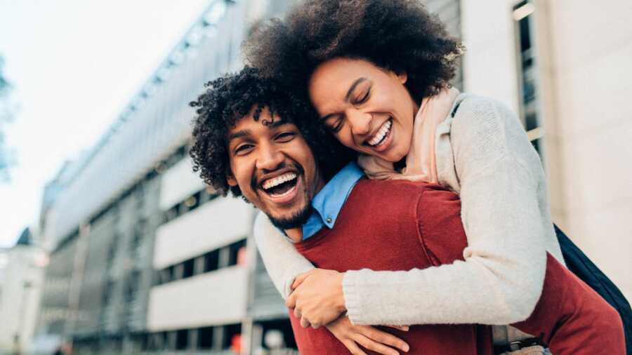 happy black couple laughing and smiling