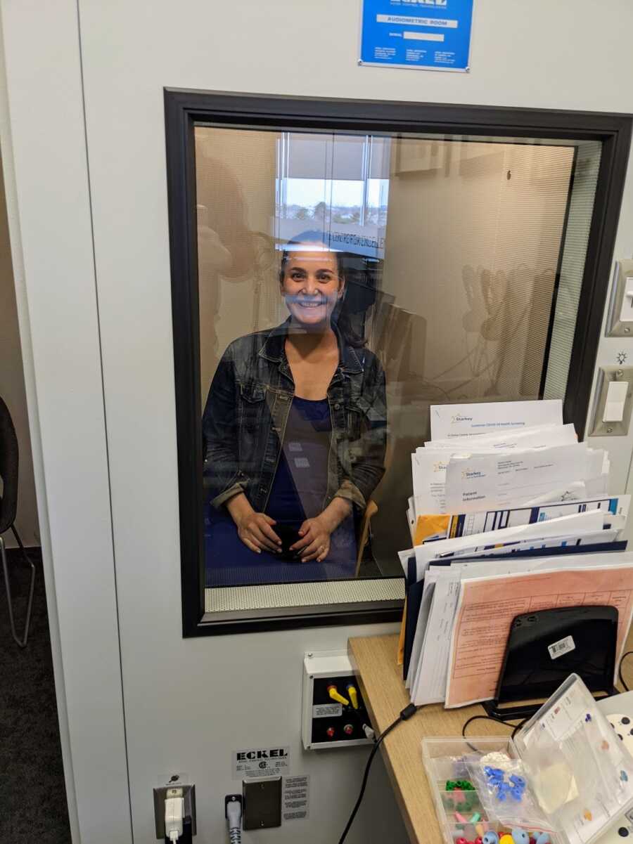 hearing disabled woman in hearing test booth