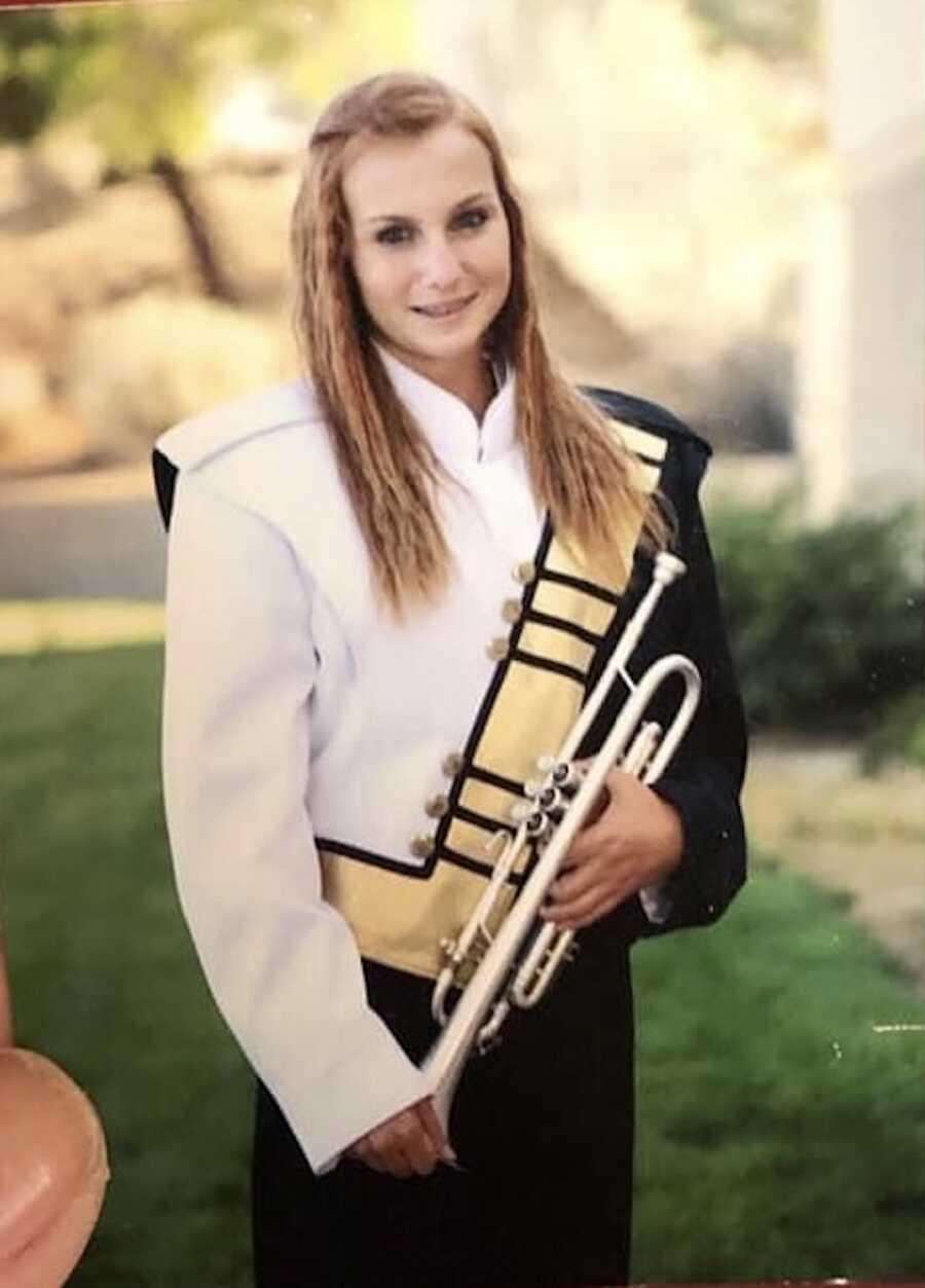high school girl in marching band uniform with trumpet