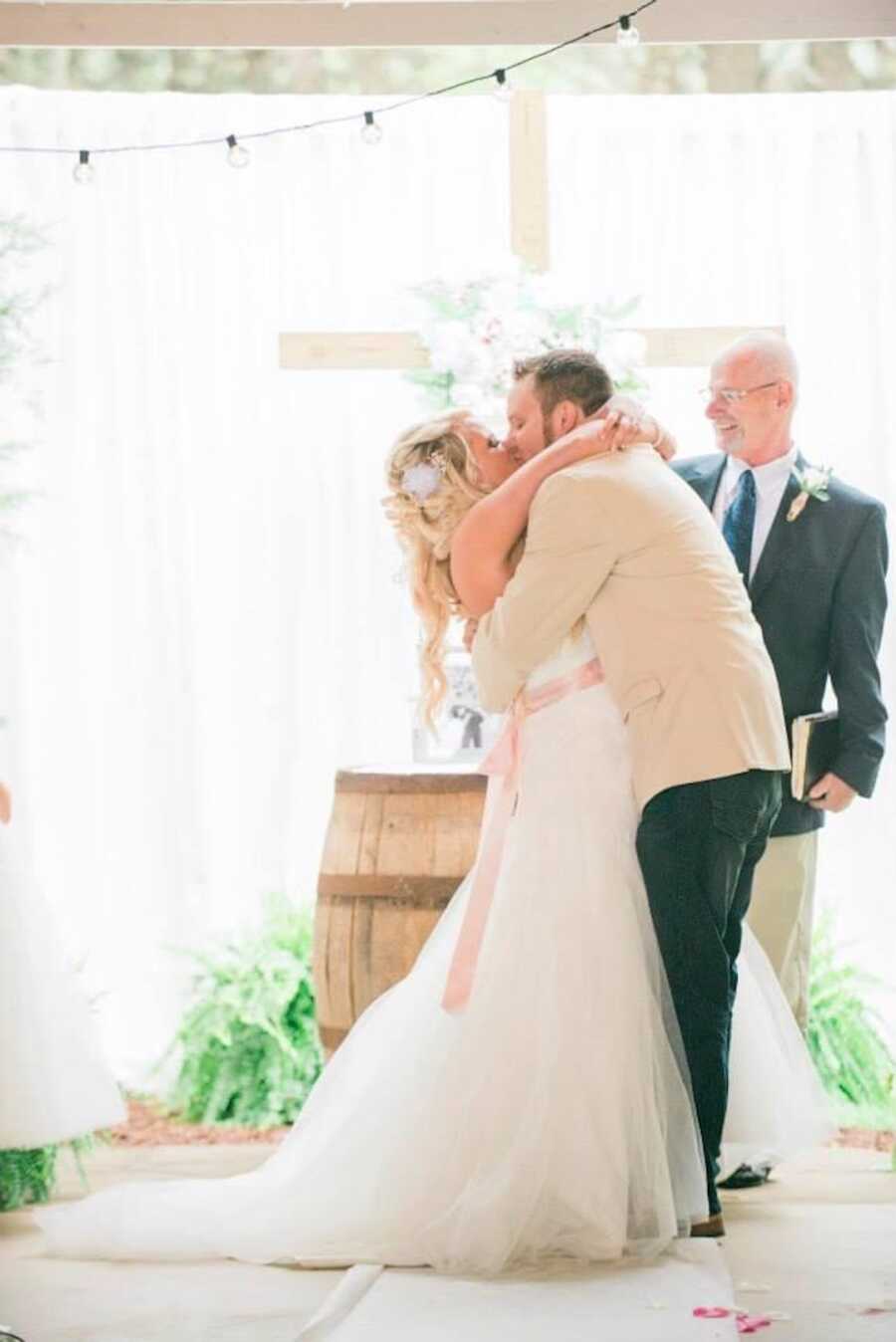 husband and wife's first kiss on their wedding day