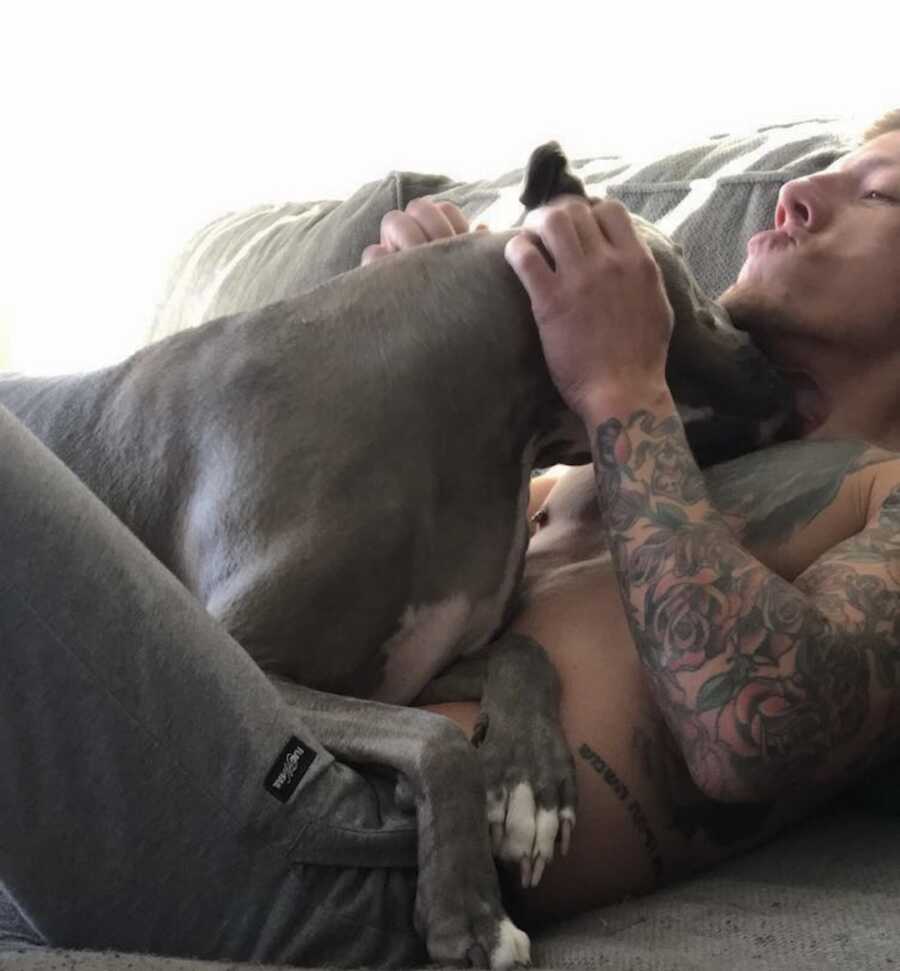 dog lays on man with Cystic Fibrosis chest