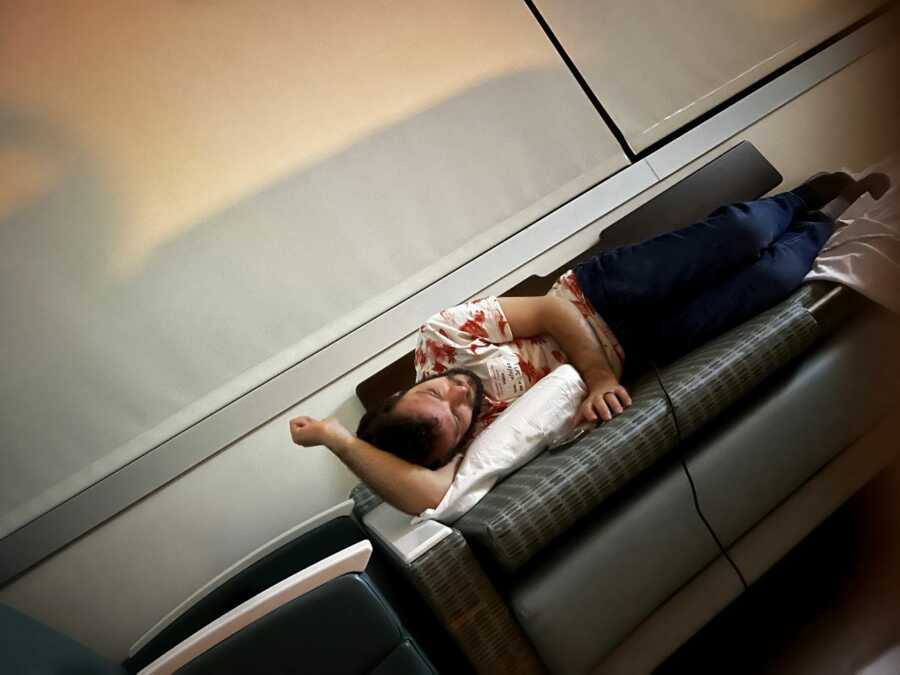 Boyfriend of chronic illness patient sleeping on hospital couch
