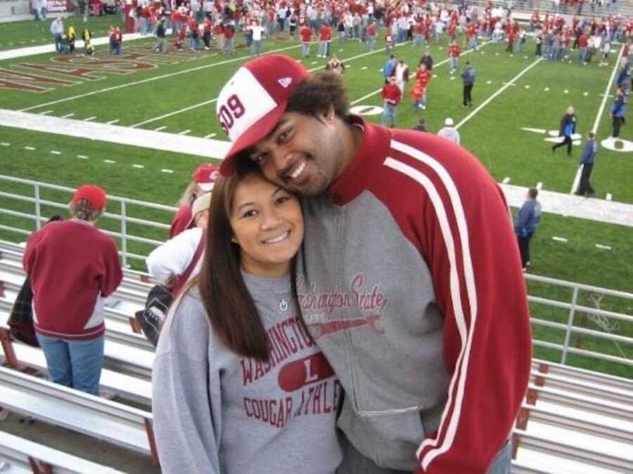 man and woman hugging at football game 