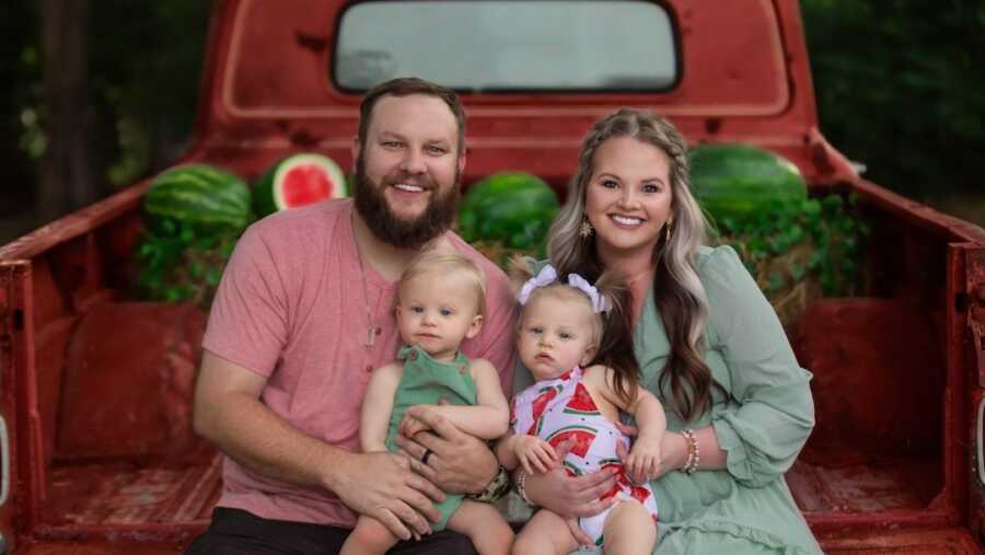 husband and wife holding their miracle twins