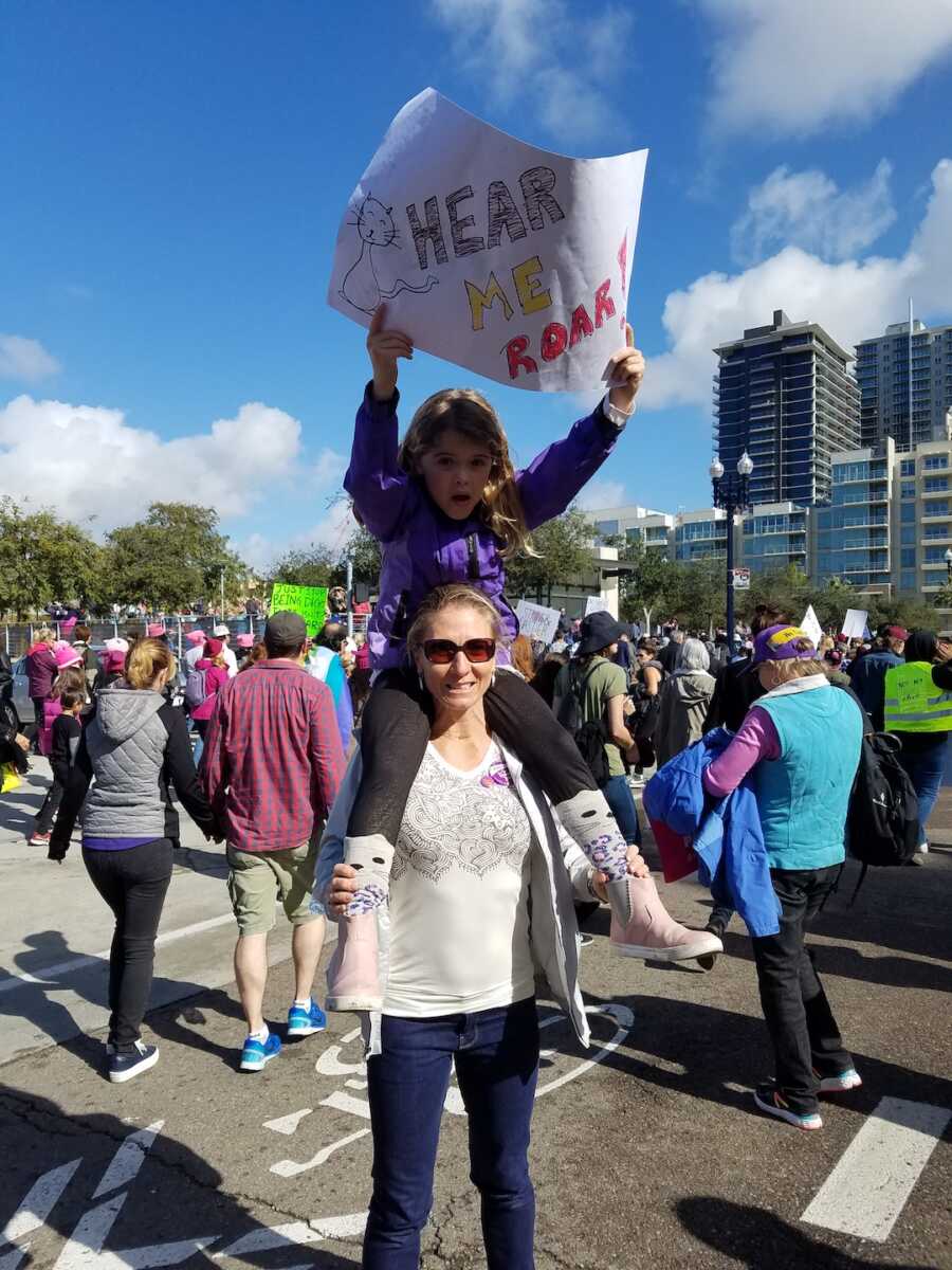 mom and daughter at women's right march