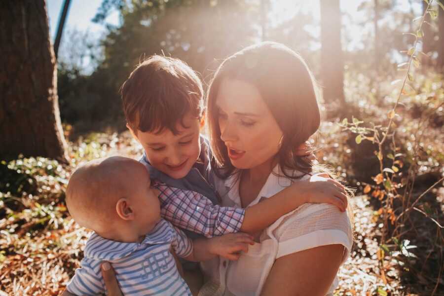 mom holds her two children close