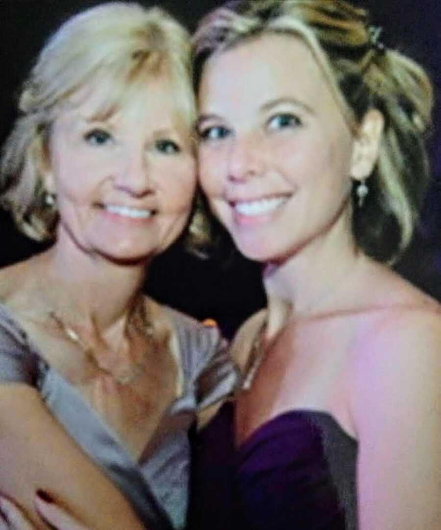 mother and daughter smiling together in fancy dresses