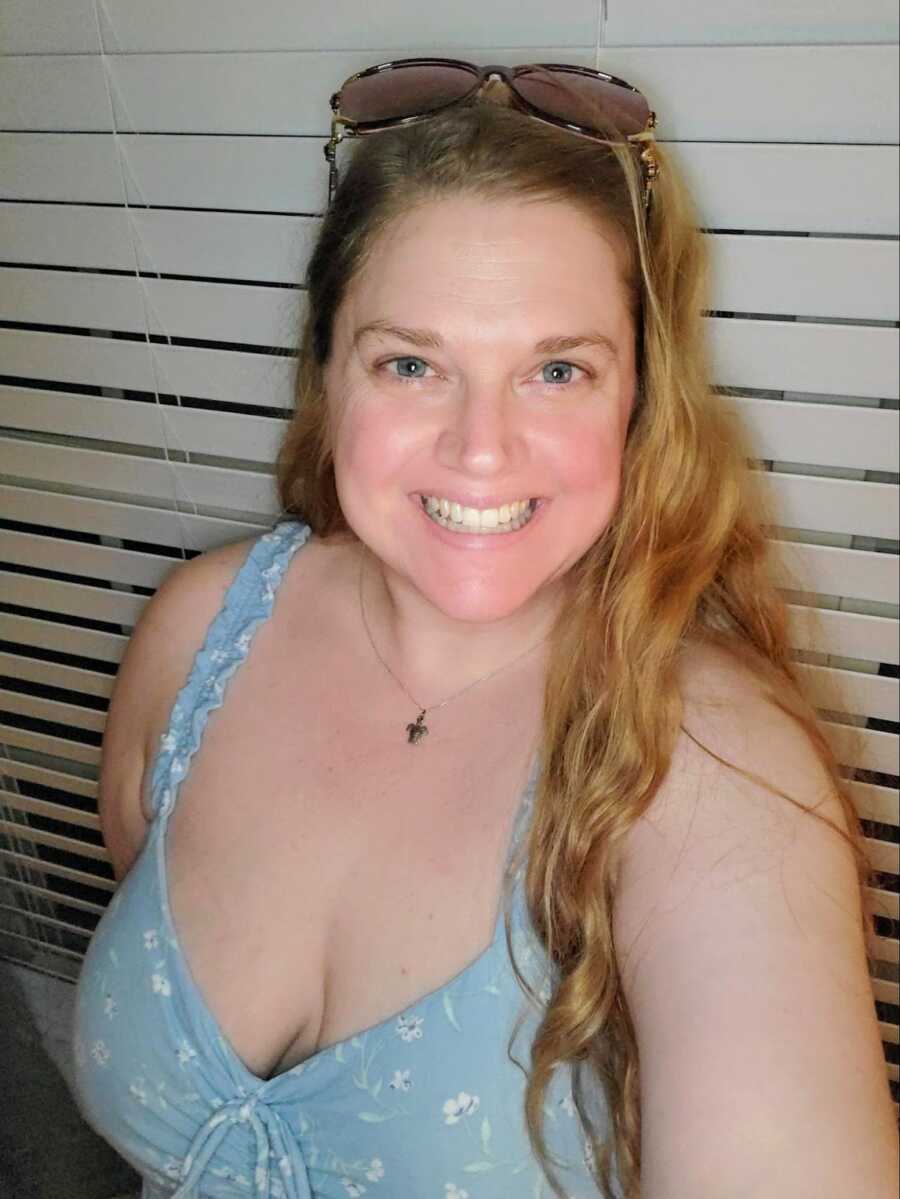 selfie of mother in low cut blue tank top