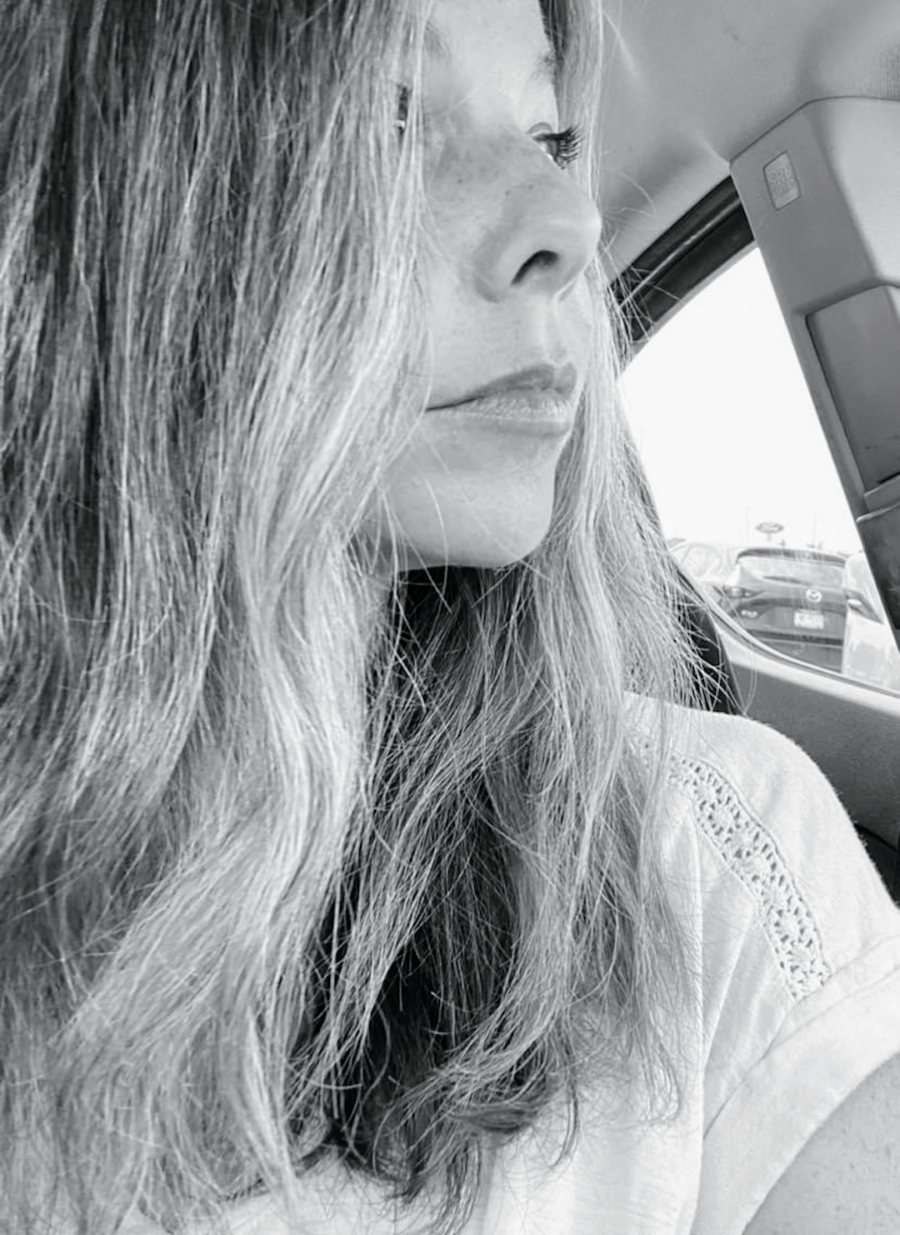 black and white photo of grieving daughter staring out of car window