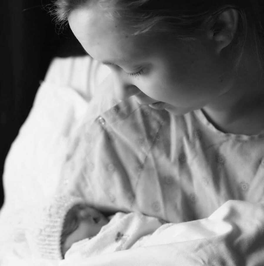 black and white photo of mother holding her stillborn daughter