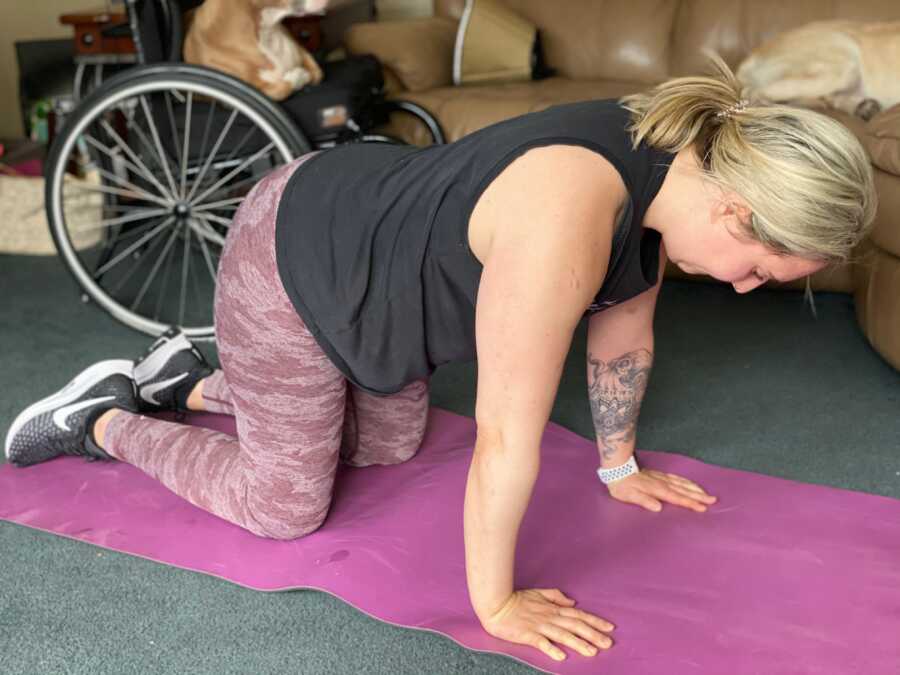 Paralyzed woman does exercises on a yoga mat