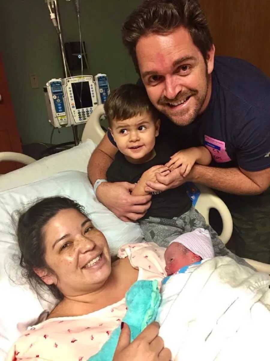 mom with husband, son, and newborn after labor and delivery