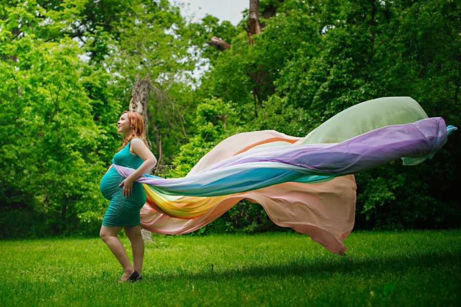 pregnant mother with billowing rainbow skirt