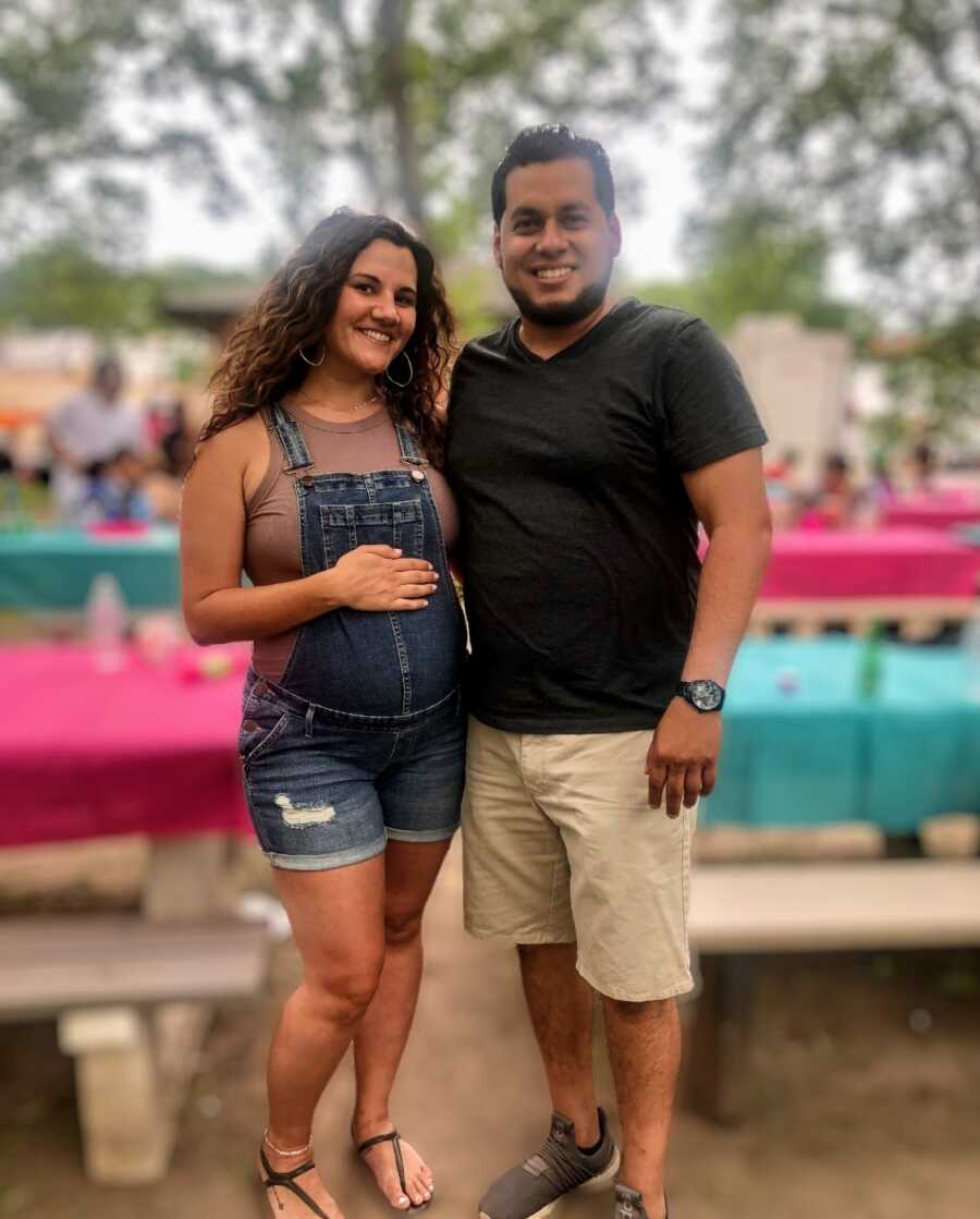 pregnant wife with her husband in front of picnic tables