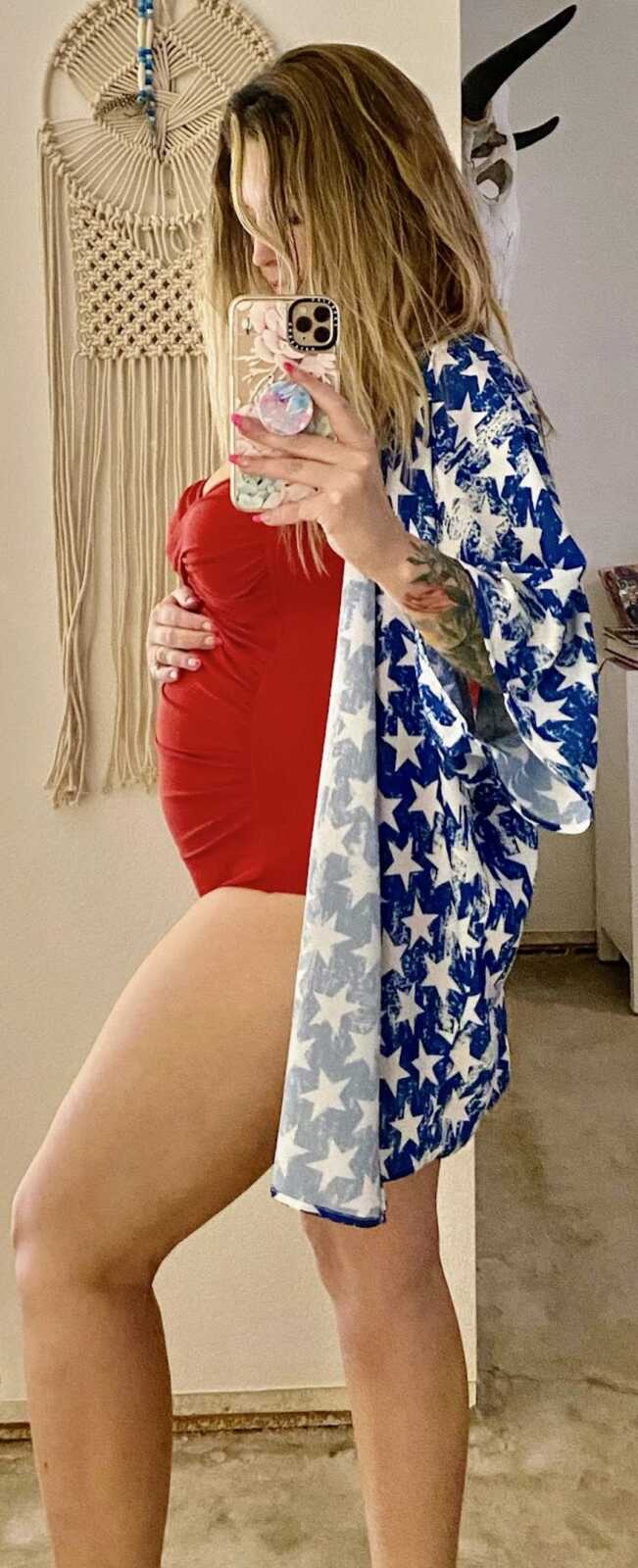 pregnant woman in a July fourth beach outfit