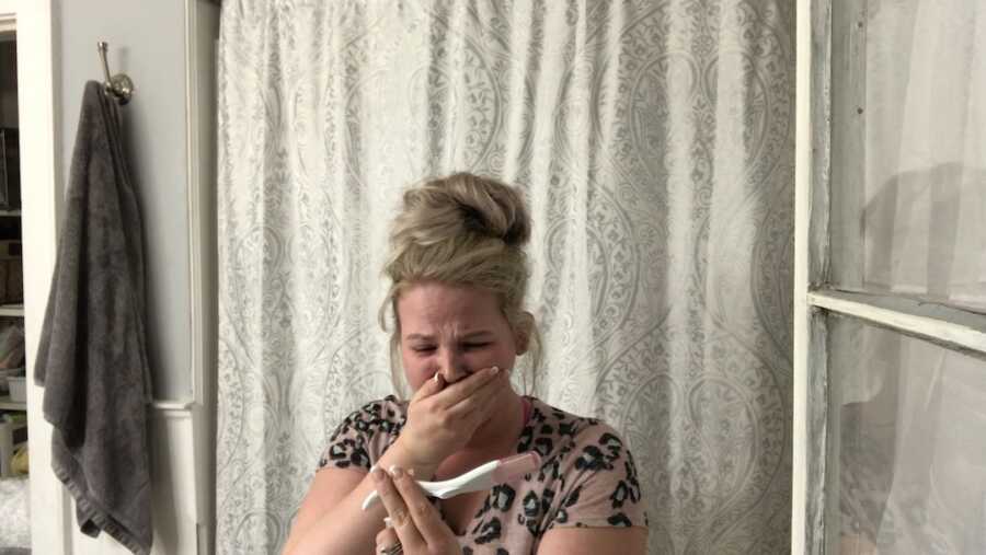 woman's reaction to positive pregnancy test