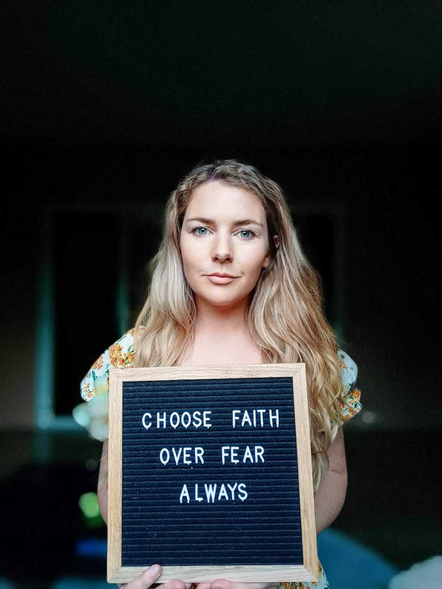 recovered alcoholic holding spirituality letter board sign