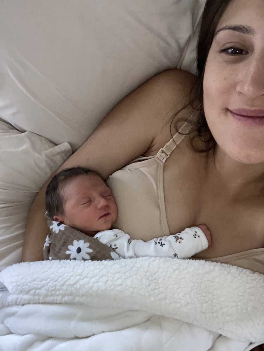 mom takes selfie with newborn baby on her chest