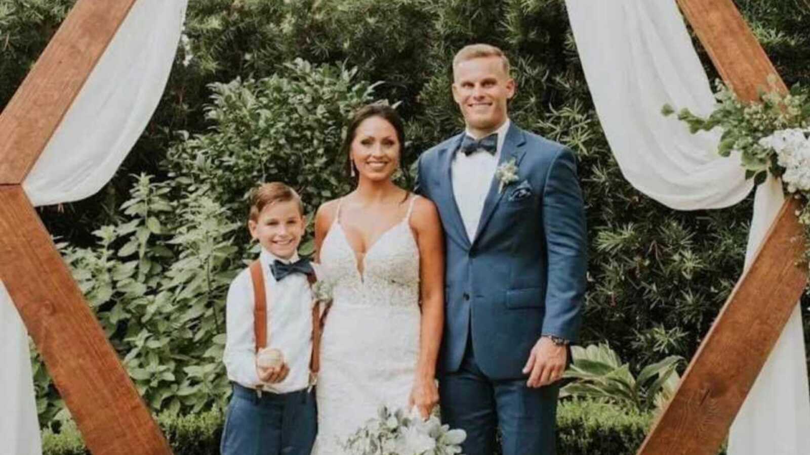 stepdad with new wife and stepson on wedding day