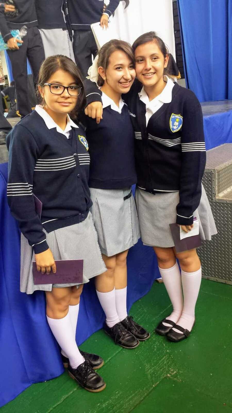 three girls in school uniforms together