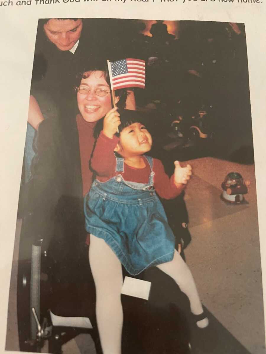 Myasthenia Gravis survivor as a baby holding up American flag