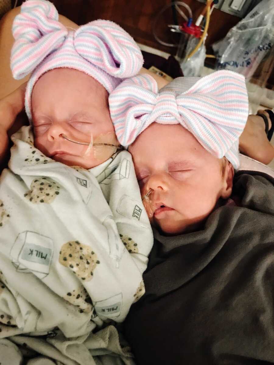 twin baby girls with breathing tubes in their noses