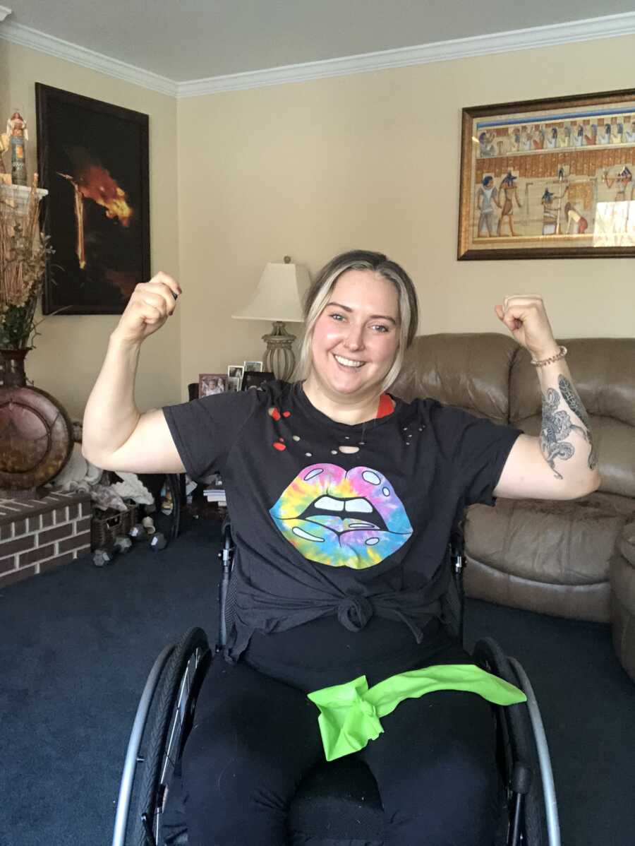 Wheelchair user flexes with a workout band