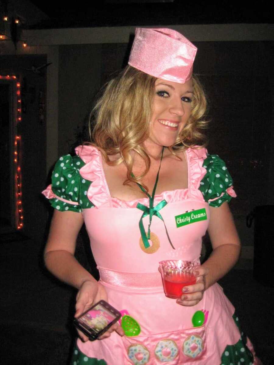 alcoholic wearing pink and green costume saying Christy creams on a name tag
