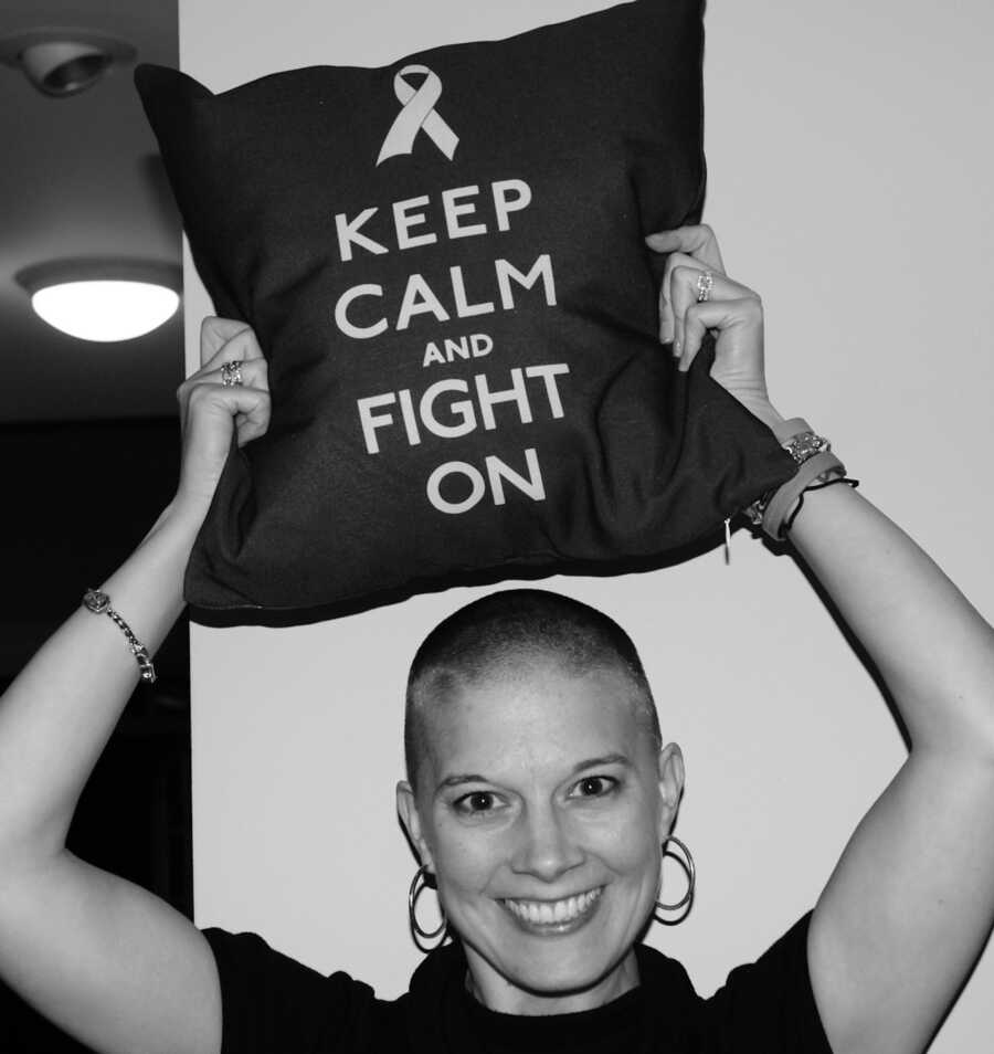 woman holding breast cancer pillow