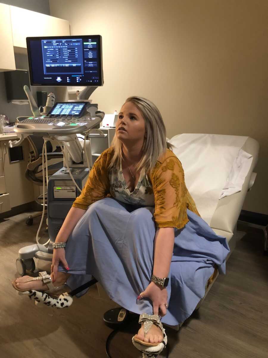 woman in exam room on table