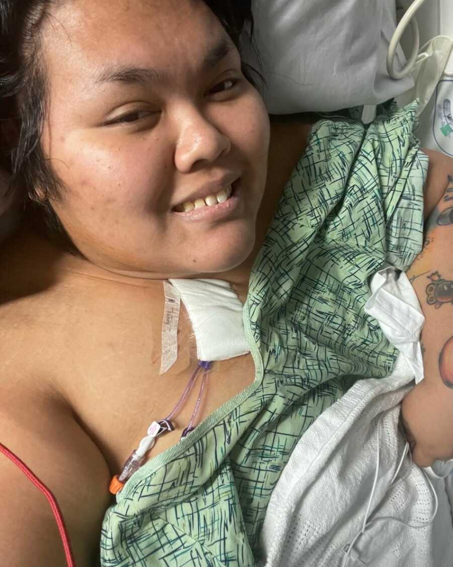 Myasthenia Gravis survivor in hospital bed and gown