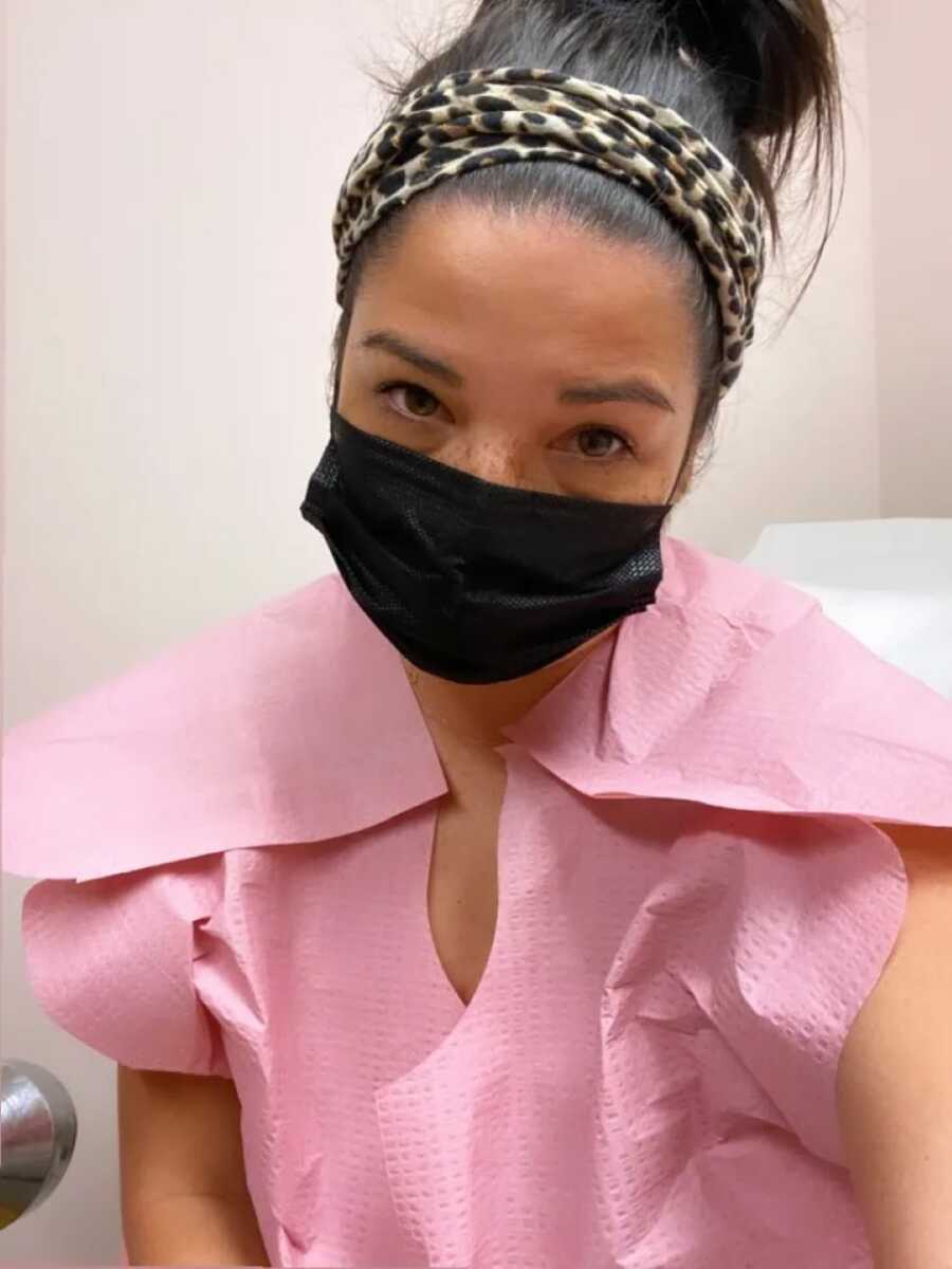 Patient in pink scrubs taking selfie in hospital hospital