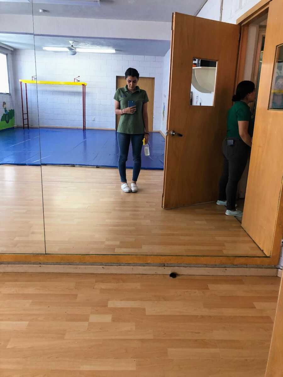 woman taking mirror photo in school uniform