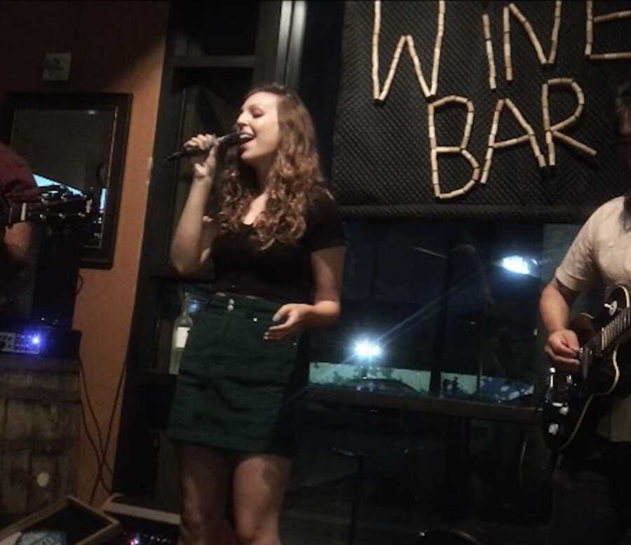 woman singing at a gig in a bar