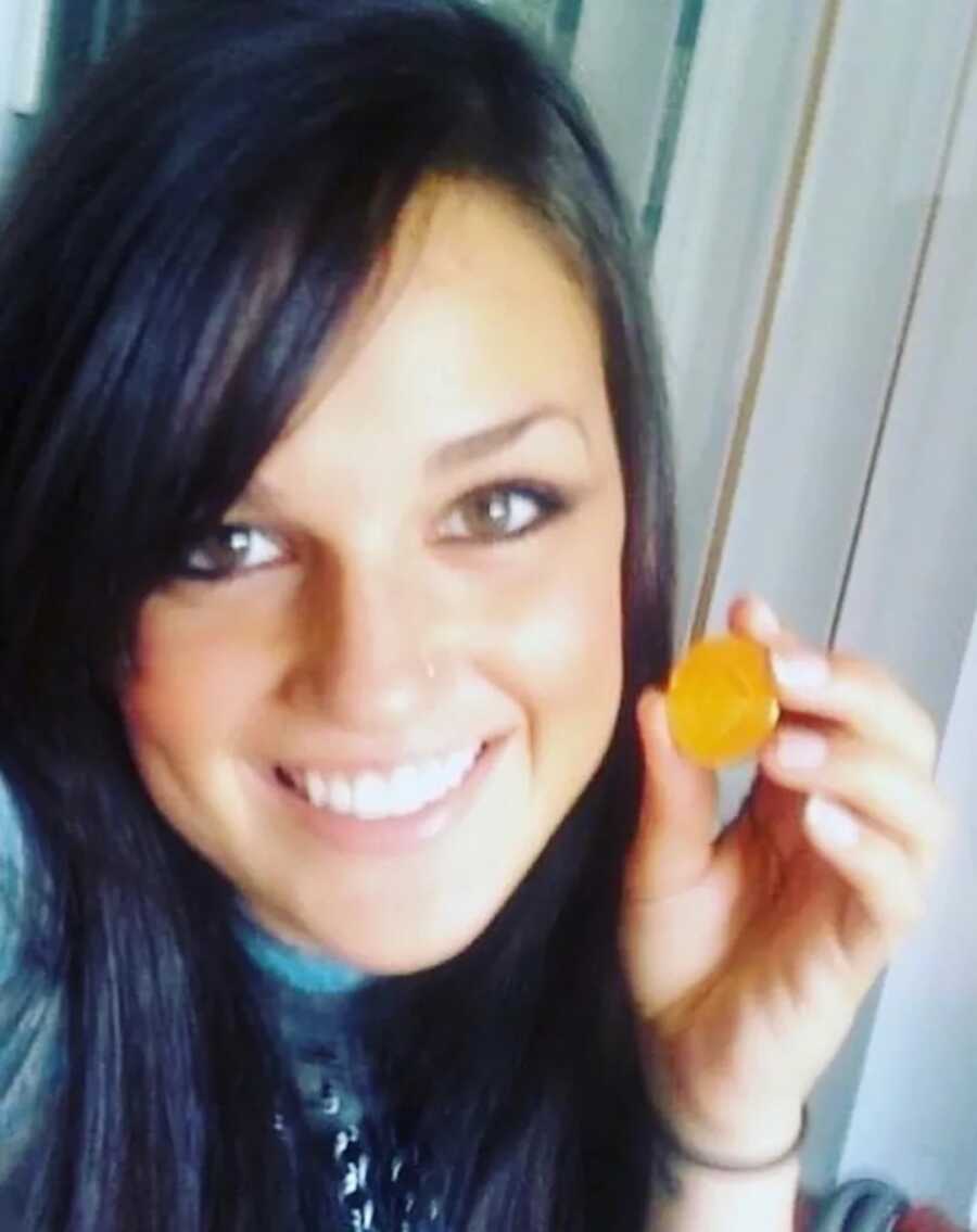 woman battling depression and addiction with 1 year sober coin